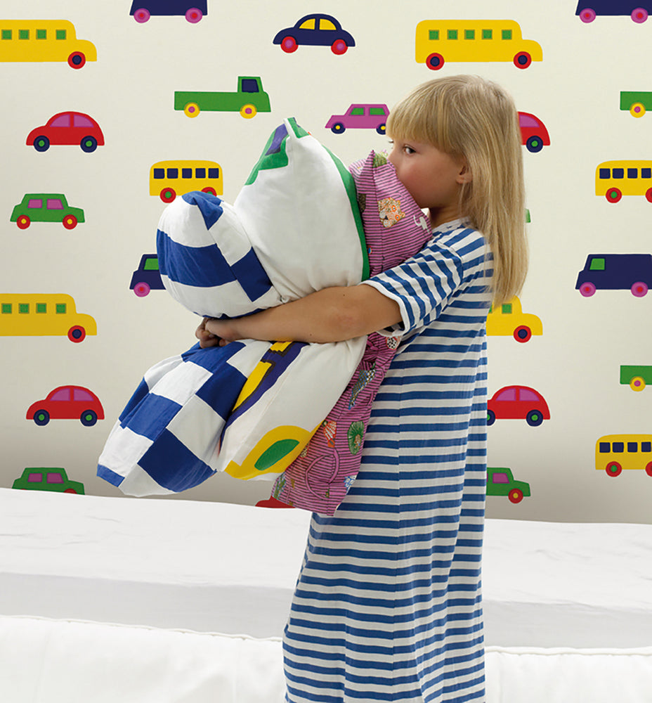 Young girl holding pillows with Marimekko Volume 5 Boboo Car Wallpaper