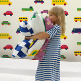 Young girl holding pillows with Marimekko Volume 5 Boboo Car Wallpaper